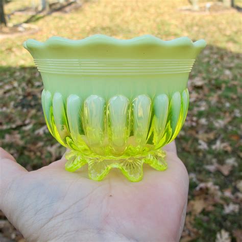 a sweet little hobnail glass basket for trinkets and jewelry, jellybeans or Easter peeps Classic green vaseline glass has a glass handle and is 4" tall and 4" across and 4" across the wide way. . Vintage vaseline glass for sale